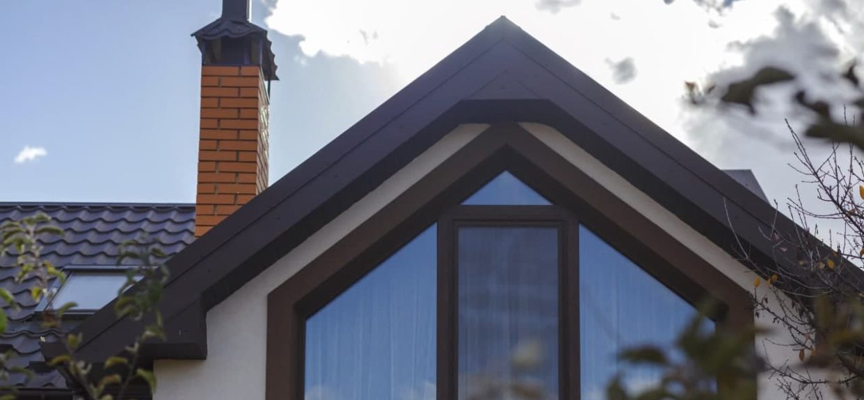 House roof with chimney and window.