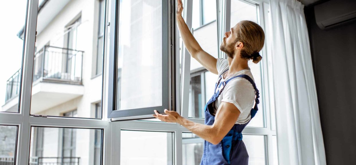 Worker inspecting a window frame