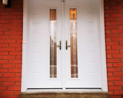 White double doors with brick wall