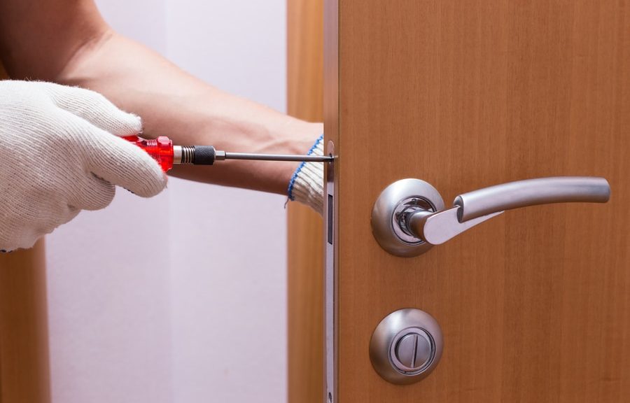 Locksmith working on door lock