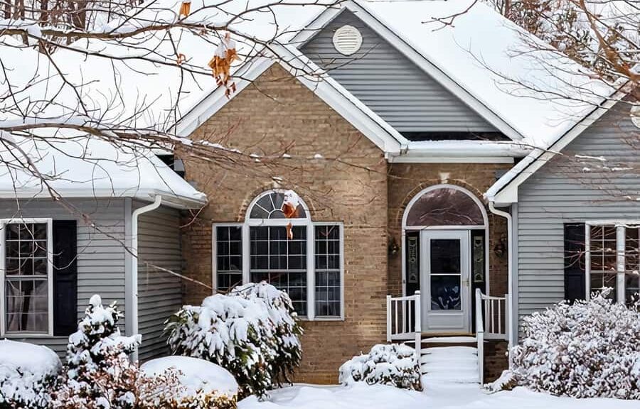 Snow-covered house in winter scene.