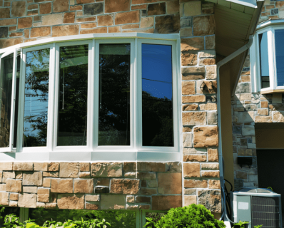 Stone house with large bay windows