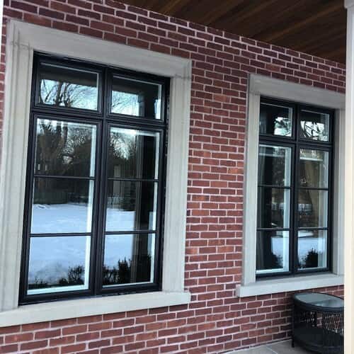 Modern black framed windows on brick wall