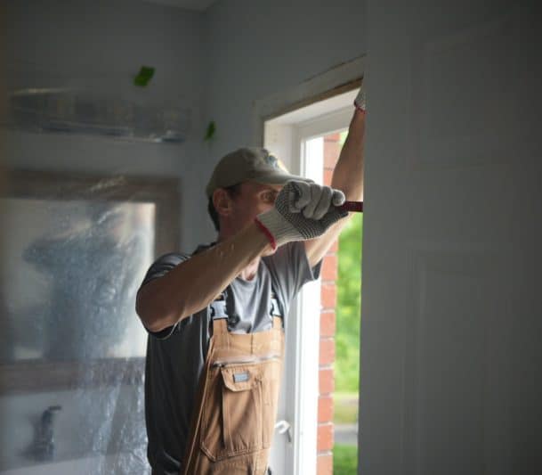 A professional installing a window in Prince George