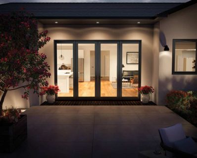 Modern home entrance with glass doors.